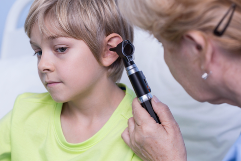Ear examination with otoscope