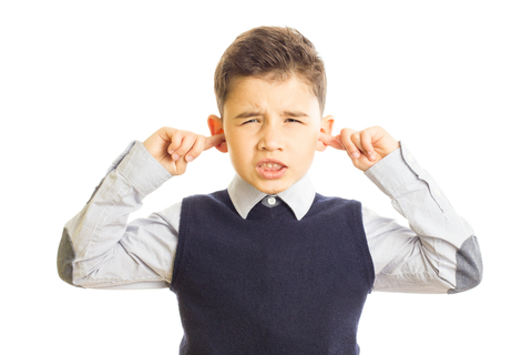 Boy with fingers in ears