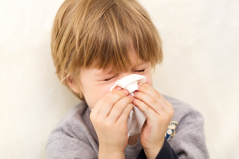 Young child sneezing